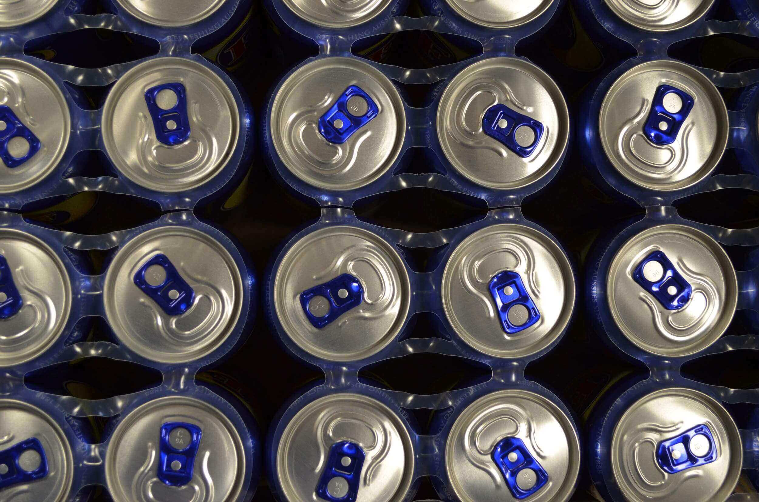 Blue soda cans with blue tabs from a top down view